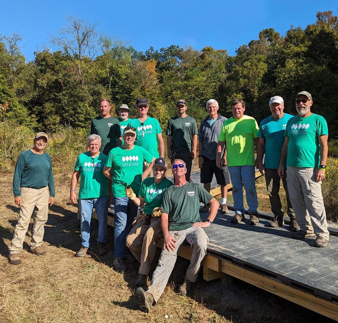 Volunteers and trails crew posing on the newly constructed boardwalk.